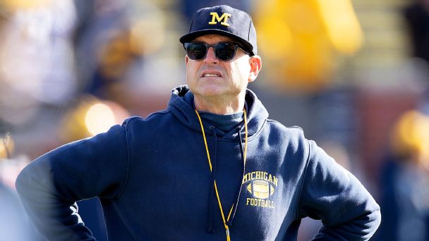 Jim Harbaugh helps clear fallen tree in Michigan ice storm