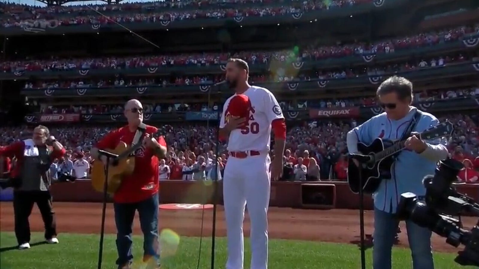 Cardinals' pitcher Adam Wainwright performs the National Anthem before playing against the Bluejays