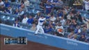 Dodgers' Freddie Freeman makes a leaping catch into the net to get out of the fourth inning