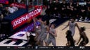 Desmond Claude soars and swats the ball into the stands to protect Xavier's lead against Winthrop