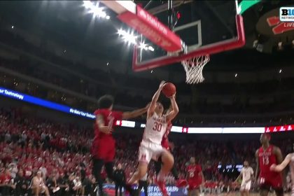 Nebraska's Keisei Tominaga drives to the basket and secures the and-1 finish