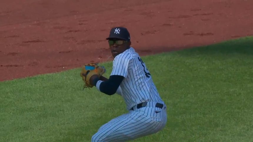 Yankees' Jazz Chisholm Jr. makes a great scoop to throw out the runner at first against the Rockies