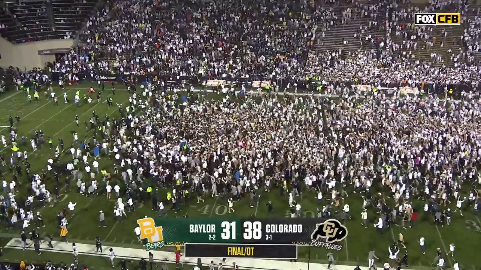 Fans storm the field after Colorado's Travis Hunter forces a Baylor fumble through the endzone and seals a 38-31 win in OT