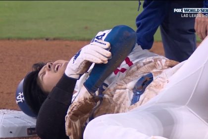 Shohei Ohtani comes up favoring his left arm after getting caught stealing to end the seventh inning in Game 2