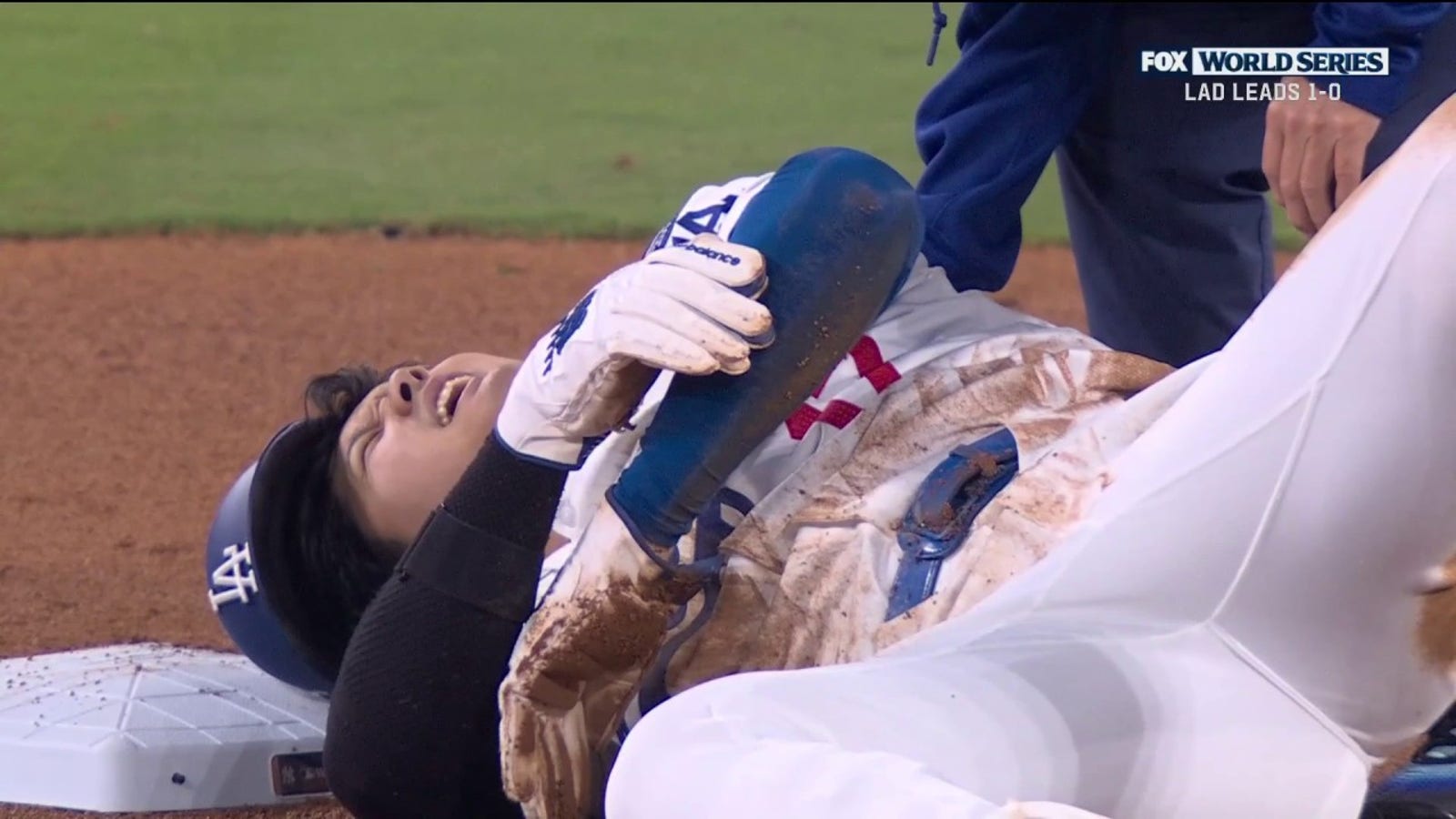 Shohei Ohtani comes up favoring his left arm after getting caught stealing to end the seventh inning in Game 2